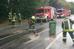Feuerwehrkräfte entfernen die Speisereste von der Fahrbahn.