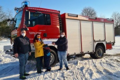 Alexandra May übergibt Ortsbrandmeister Tobis Burmeister (Mitte) und Sebastian Meinen die Steine.