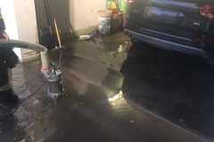 Eine überflutete Garage wird von der Feuerwehr leergepumpt.